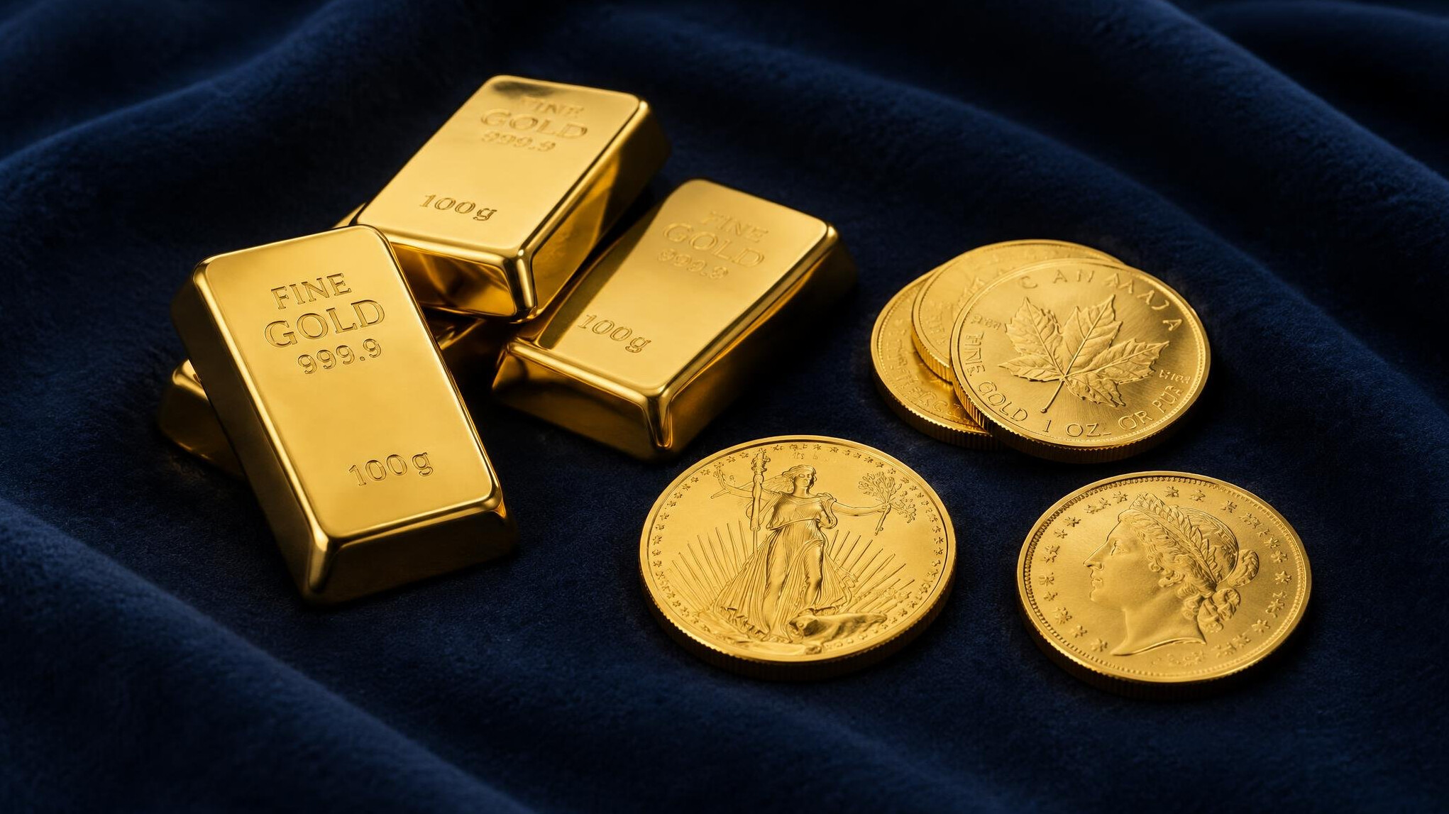 Small gold bars and gold coins on a dark cloth